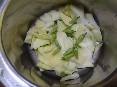 peel and cut raw mango for appe kayi saaru