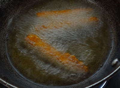 sliced baby corns in the batter for baby corn golden fry