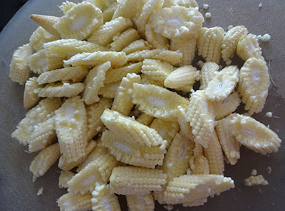 slicing the baby corns for baby corn manchurian