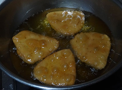 deep frying badam puri or badami poori