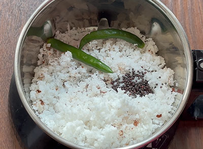 grinding coconut, green chillies and mustard for bale dindu mosaru sasive or banana stem raita