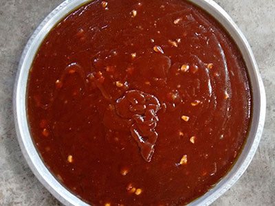 pouring the balehannu or banana halwa to the greased plate