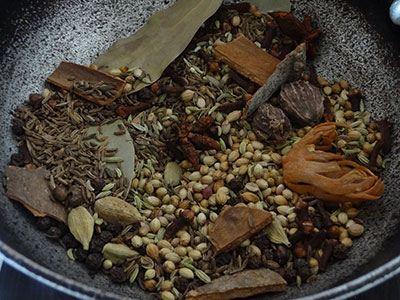 warming the spices for biriyani masala powder