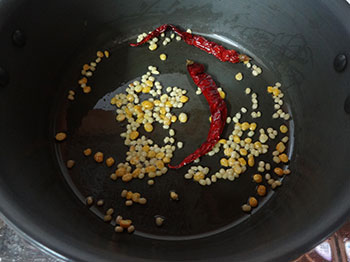 frying chili and dals for bisi bele bath