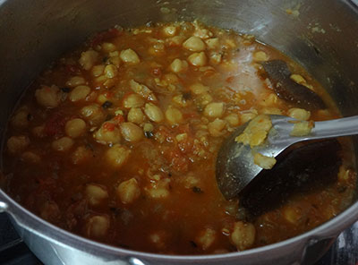 mashing chana for chana masala or chole masala