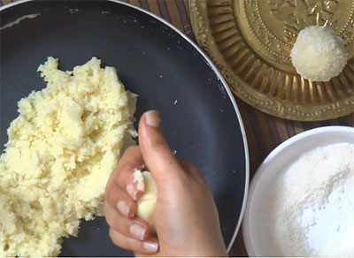 shaping the coconut and milk powder ladoo or laddu