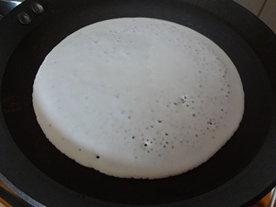 pouring batter to make curd dosa