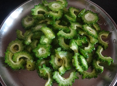 sliced bittergourd for hagalakai pakoda or bittergourd chips or karela fry