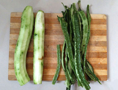 peeling ridgegourd for ridge gourd dosa or heerekai dose