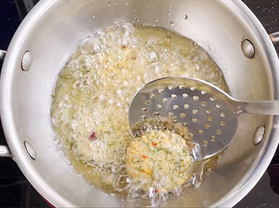 deep frying hurigadale ambode or fried gram masala vada