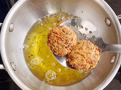 deep frying hurigadale ambode or fried gram masala vada