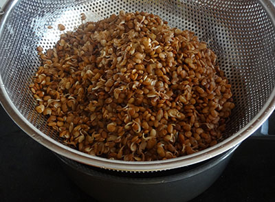 draining stock from cooked horse gram for huruli kalu bassaru