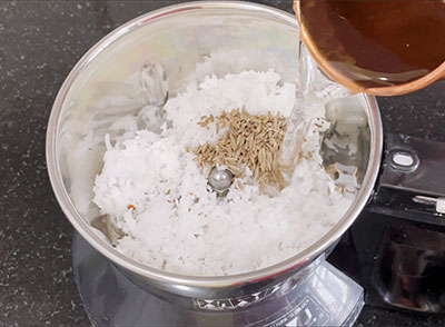 grinding coconut and cumin seeds for jeerige ganji recipe