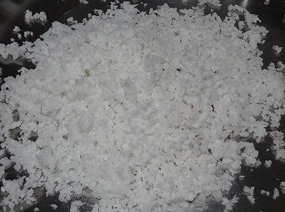 grate coconut for kayi burfi or coconut burfi