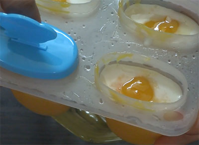 pour mango puree into cup for mango coconut milk popsicles