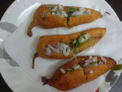 stuffing after frying the stuffed menasinakayi bajji or chilli bajji