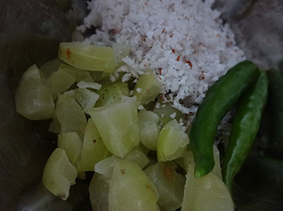 grind gooseberry and coconut for nellikai chutney or amla chutney