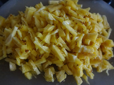 chopping pineapple for pineaple menaskai or ananas gojju