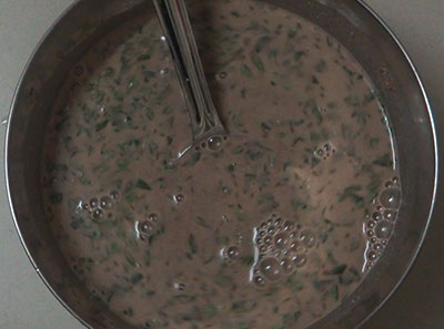 preparing batter for ragi dosa or raagi dose