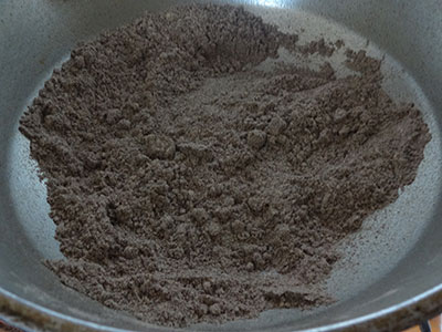 frying ragi flour for ragi laddu or ragi unde