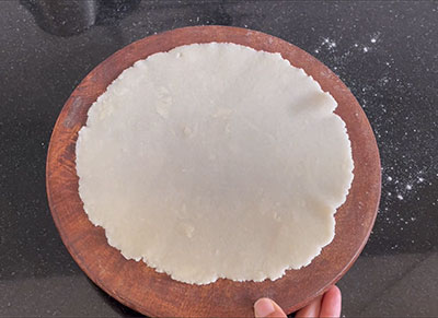 rolling the roti for rave rotti or plain rava roti recipe