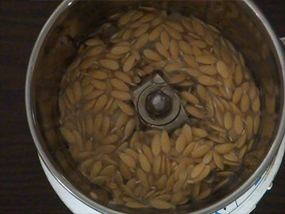 grinding cucumber seeds for southe beejada saru or cucumber seeds rasam