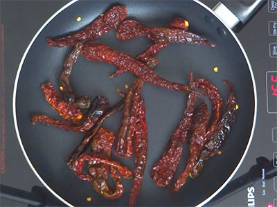 frying red chilis for udupi rasam powder or saaru pudi