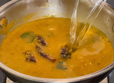 boiling veelyadele saaru or betel leaf rasam